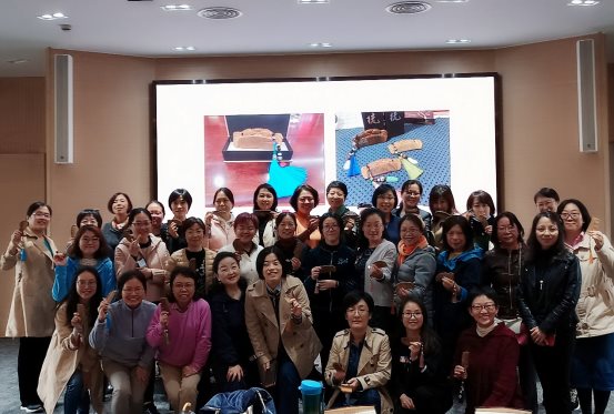 一群人站在画前合影
描述已自动生成